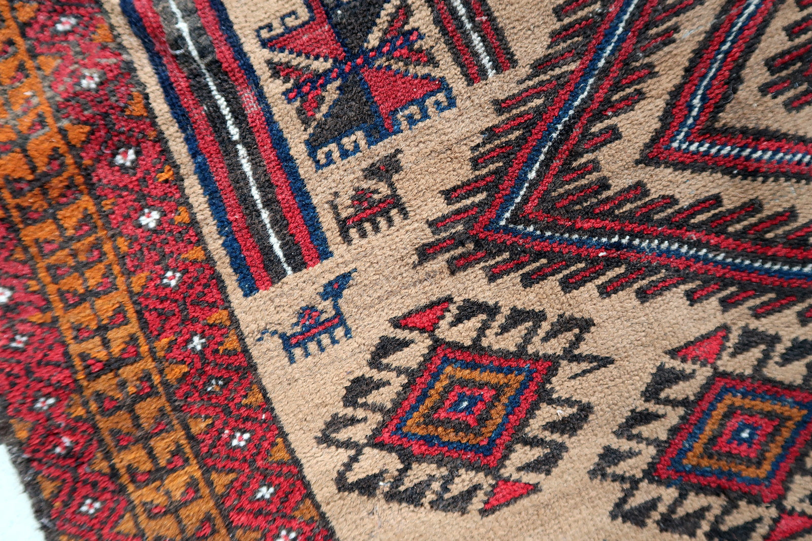 Handmade antique Afghan Baluch rug in tribal prayer design. The rug is from the beginning of 20th century in original condition, it has some low pile.