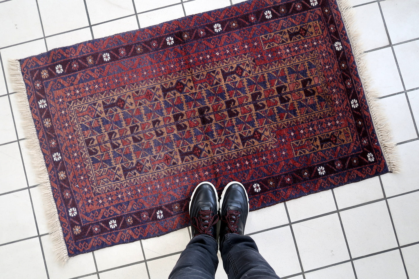 Handmade vintage Afghan Baluch rug in prayer design. The rug is from the end of 20th century in original good condition.