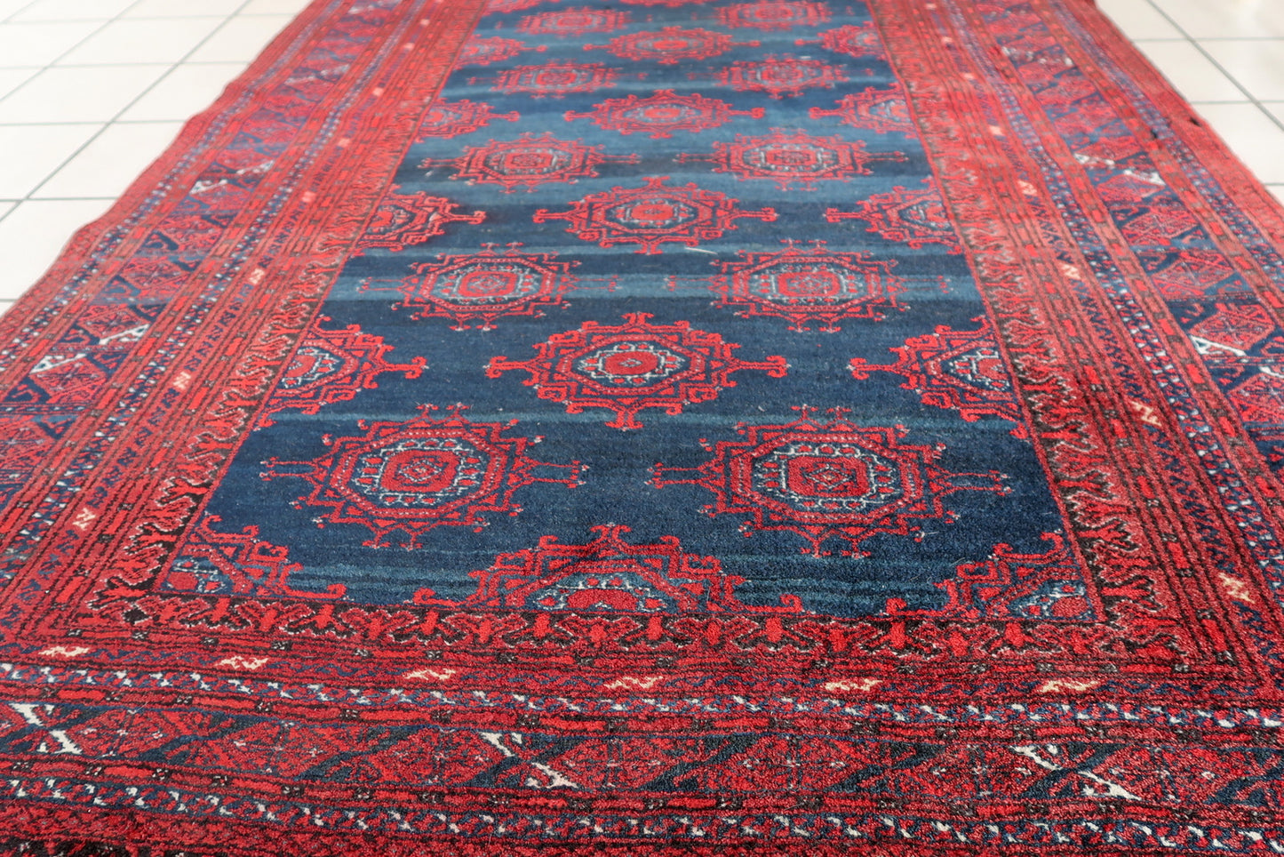 Handmade vintage Afghan Baluch rug in bright red and dark blue shades. The rug is from the middle of 20th century in original good condition.