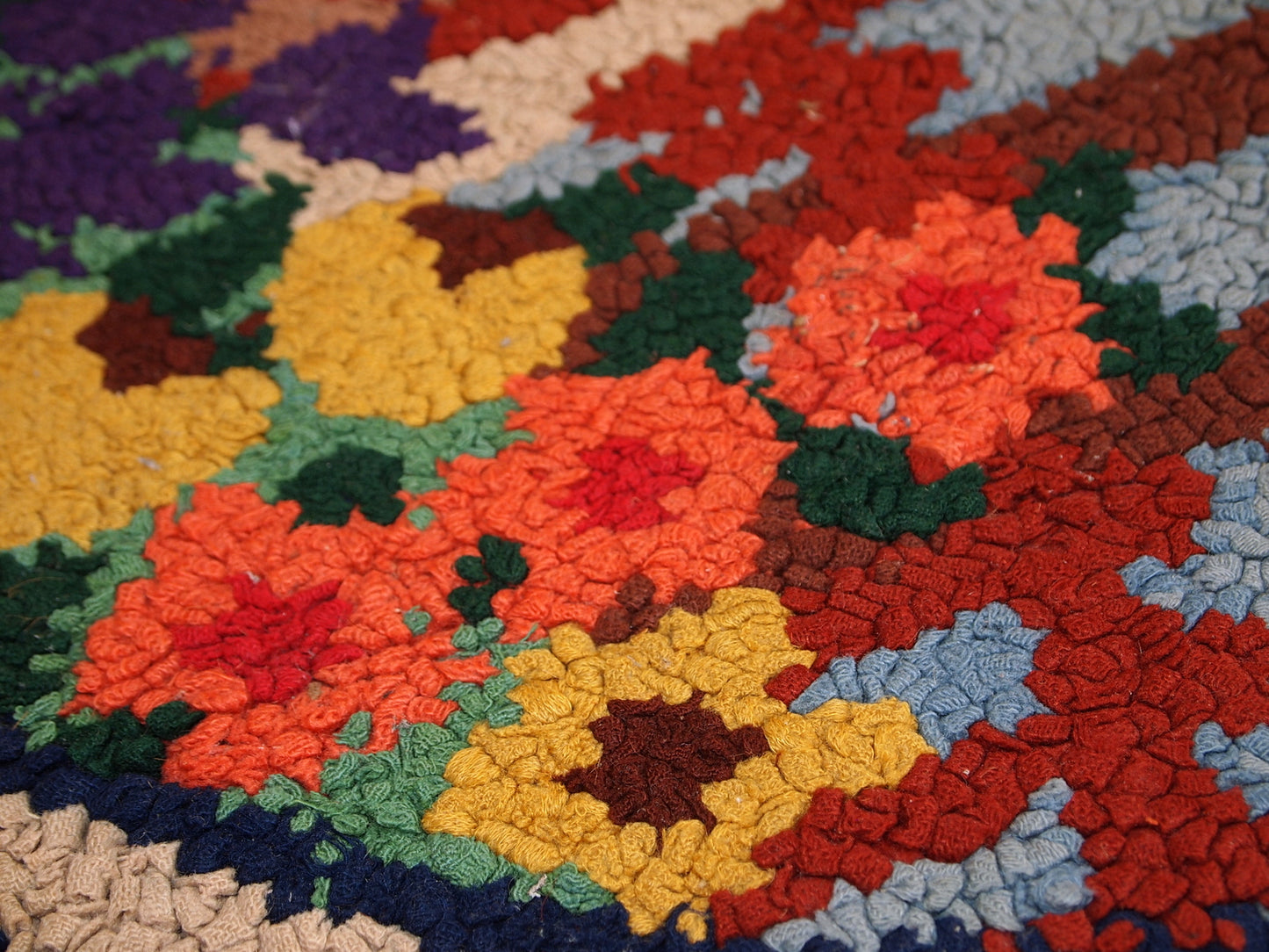 Close-up of the red elements in the rug's pastoral scene.