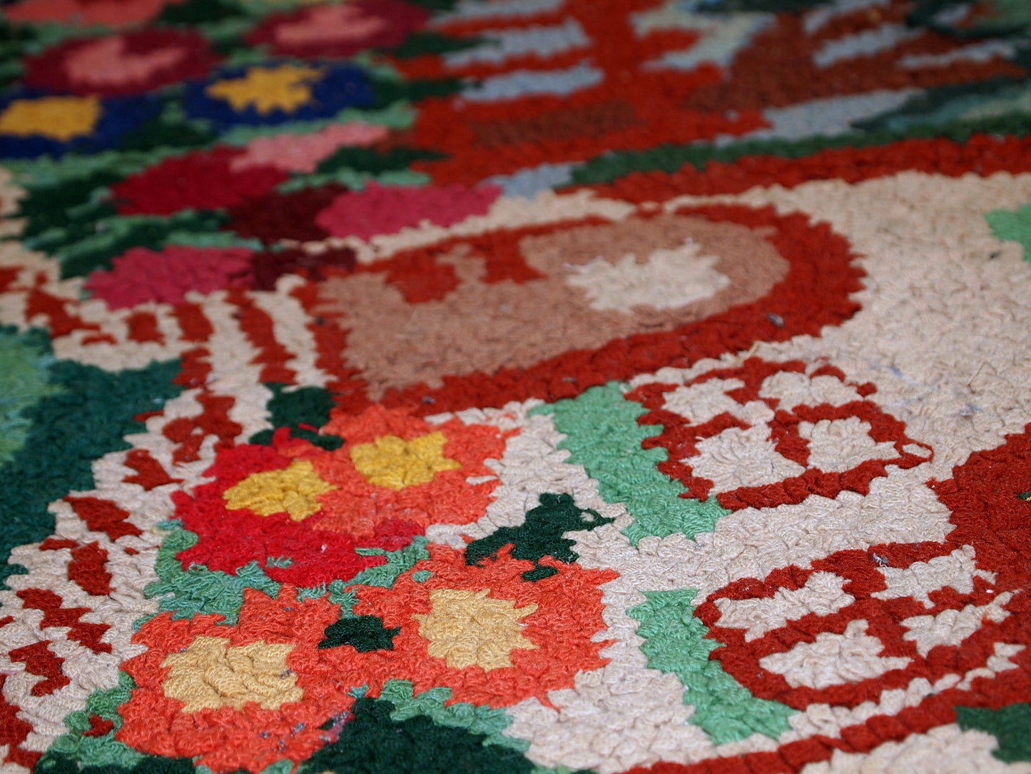 Detailed view of the charming cottage in the rug's design.
