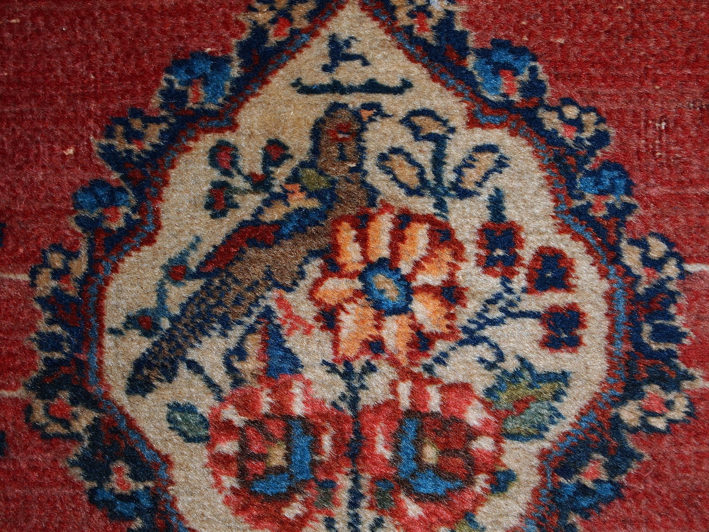 Antique Tabriz double mat in original good condition, one of the rugs has some low pile. The design is traditional with decorative birds in the center.