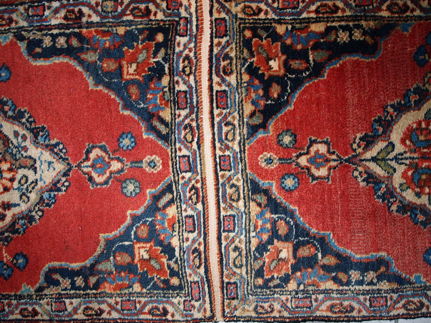 Antique Tabriz double mat in original good condition, one of the rugs has some low pile. The design is traditional with decorative birds in the center.