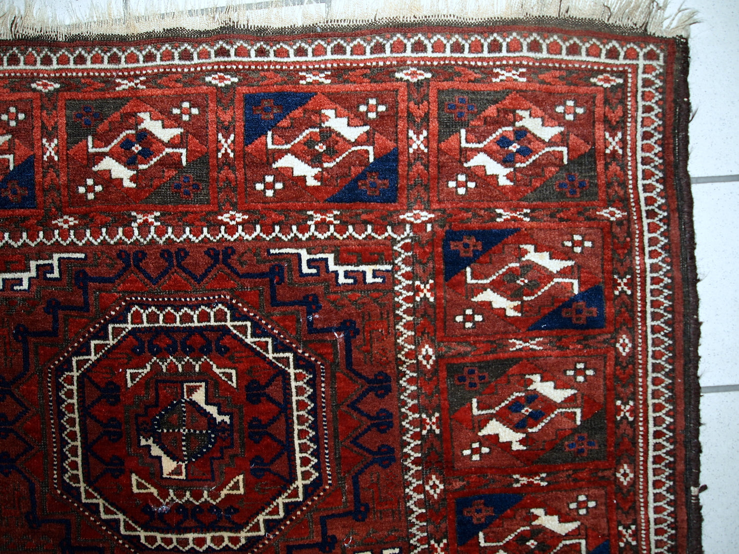 Antique hand made Afghan Baluch rug in original condition, has some age wear. The rug is in traditional deep burgundy shade with navy blue and white accents, has very rich combination of colors.