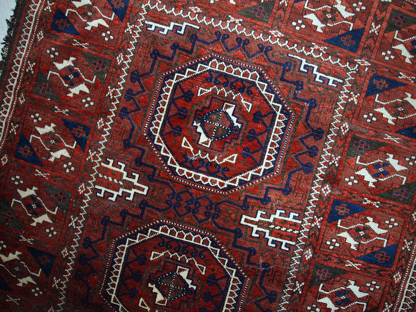Antique hand made Afghan Baluch rug in original condition, has some age wear. The rug is in traditional deep burgundy shade with navy blue and white accents, has very rich combination of colors.