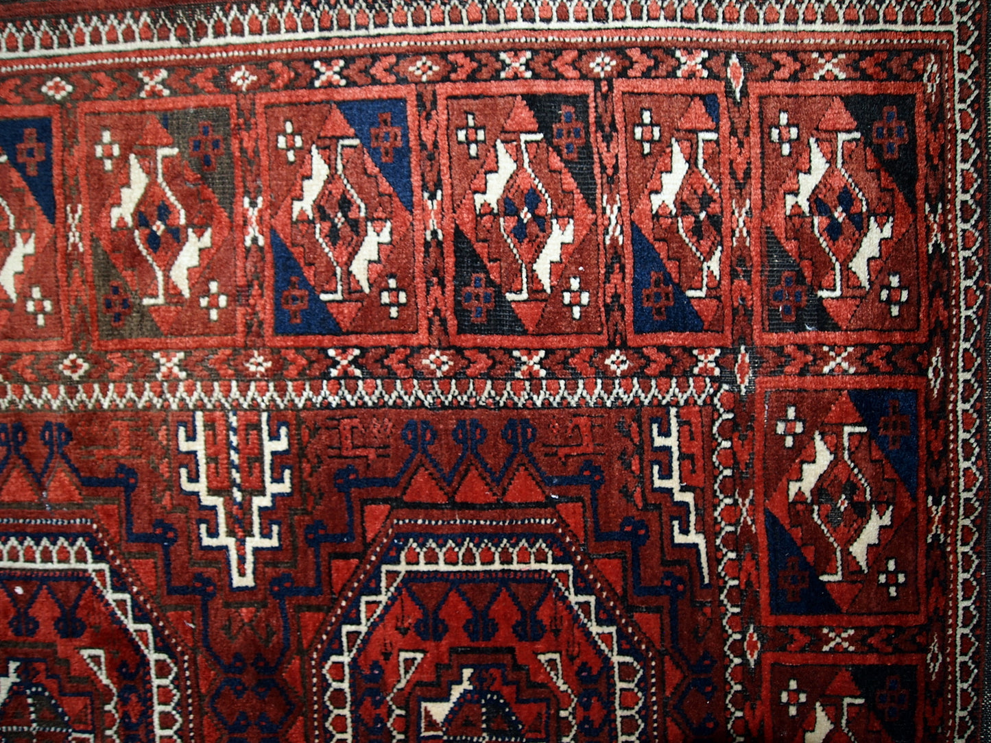 Antique hand made Afghan Baluch rug in original condition, has some age wear. The rug is in traditional deep burgundy shade with navy blue and white accents, has very rich combination of colors.