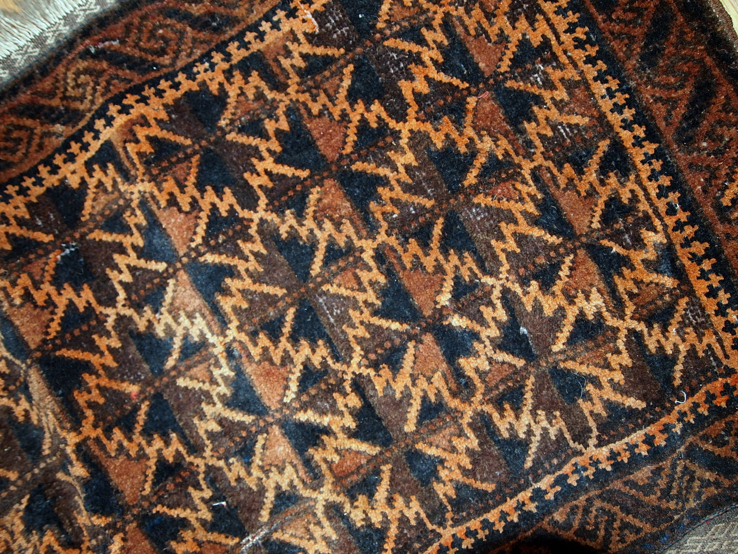 Antique hand made Afghan Baluch bag face in original condition, has some age wear and a little bit crooked. The main colors on this rug is orange, also has some different shades of brown.