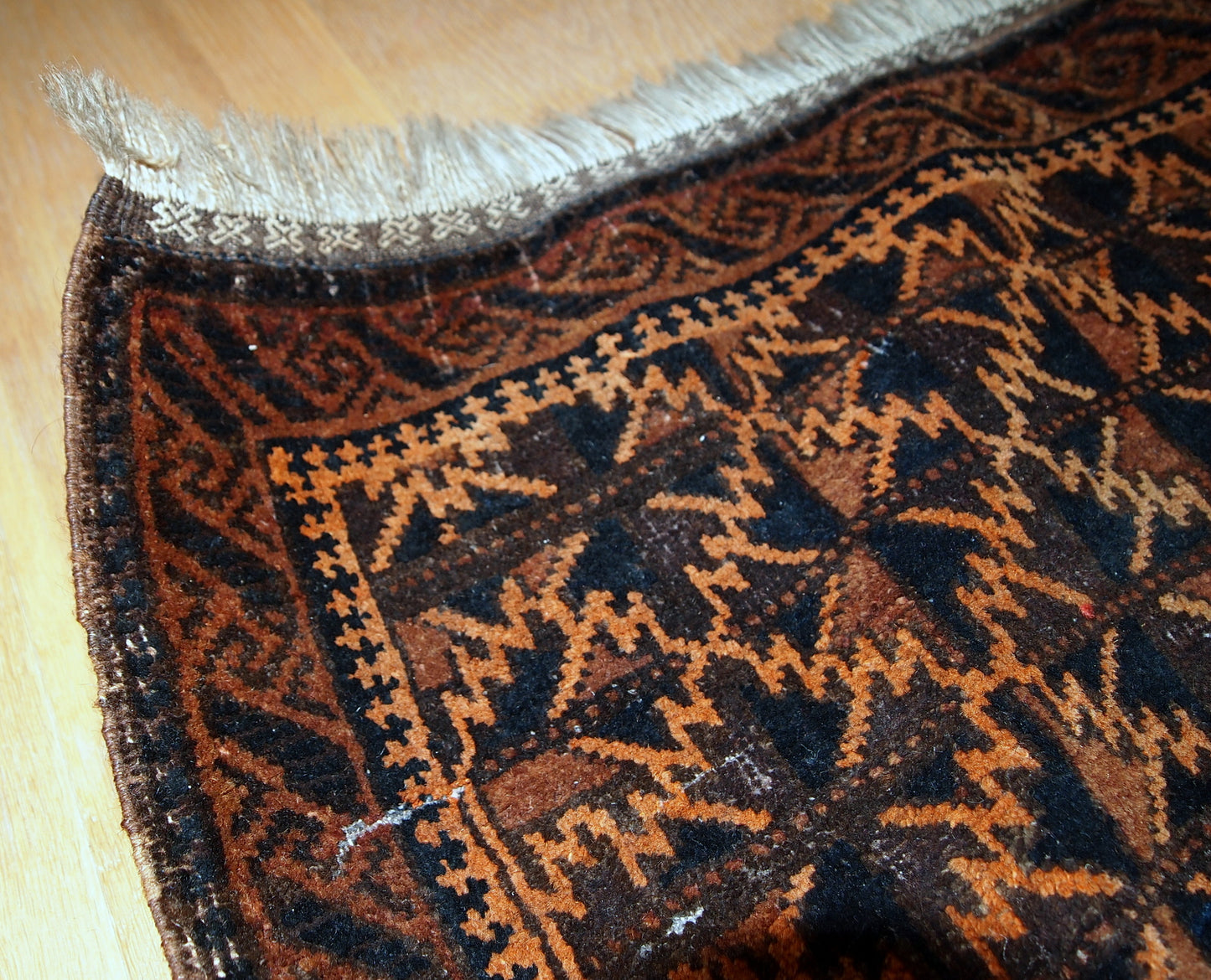 Antique hand made Afghan Baluch bag face in original condition, has some age wear and a little bit crooked. The main colors on this rug is orange, also has some different shades of brown.