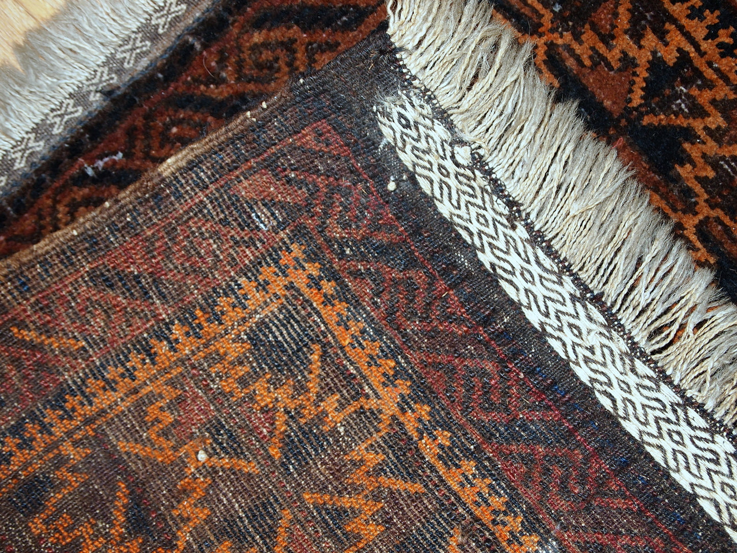 Antique hand made Afghan Baluch bag face in original condition, has some age wear and a little bit crooked. The main colors on this rug is orange, also has some different shades of brown.