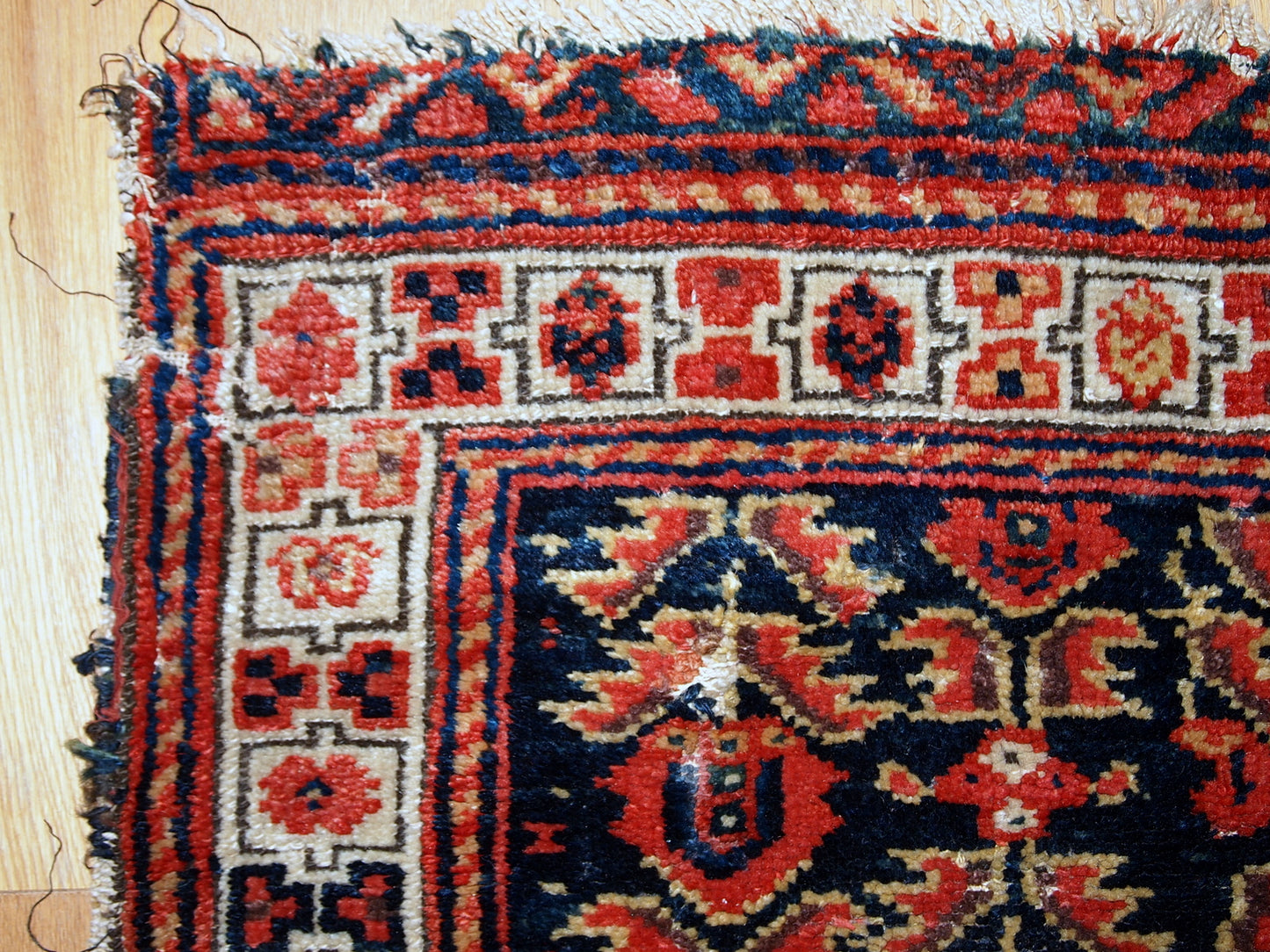 Hand made antique Malayer bag face in original condition with some age wear. The rug made has traditional tribal design in navy blue, white and red shades.