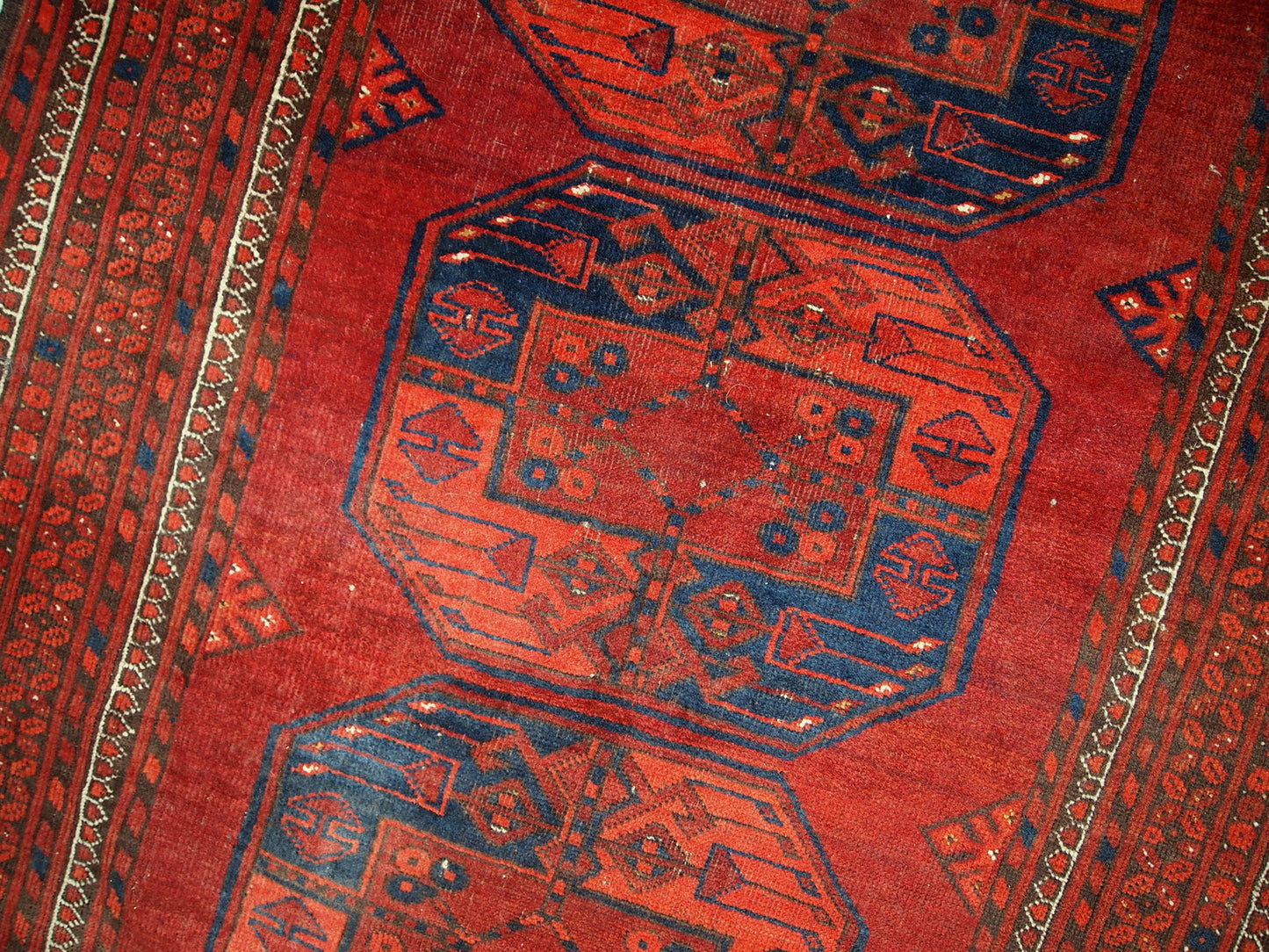Antique Afghan Ersari rug in original condition, it has some low pile. The rug is from the mid 20th century made in red wool.