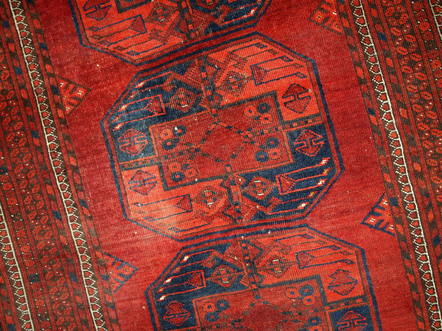 Antique Afghan Ersari rug in original condition, it has some low pile. The rug is from the mid 20th century made in red wool.