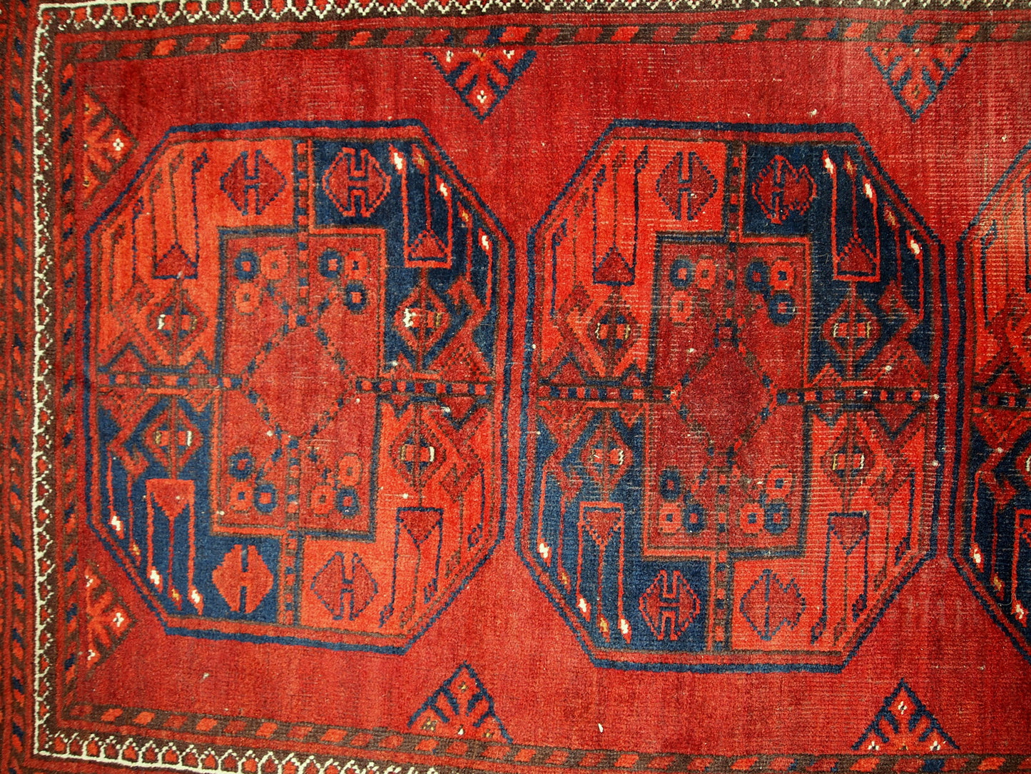 Antique Afghan Ersari rug in original condition, it has some low pile. The rug is from the mid 20th century made in red wool.