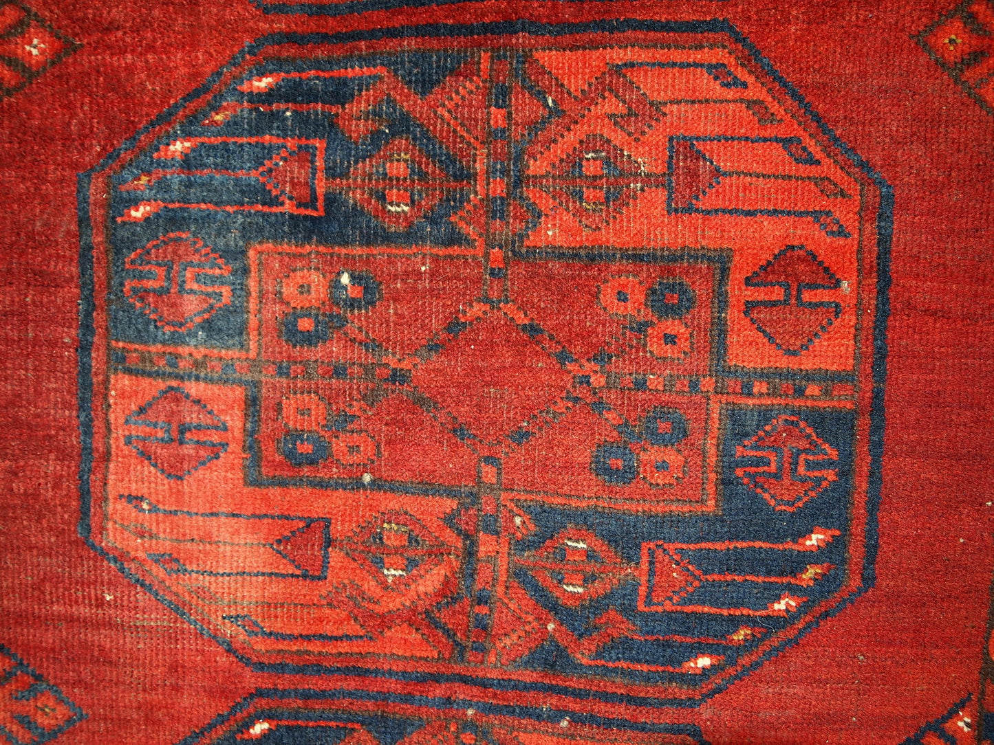 Antique Afghan Ersari rug in original condition, it has some low pile. The rug is from the mid 20th century made in red wool.