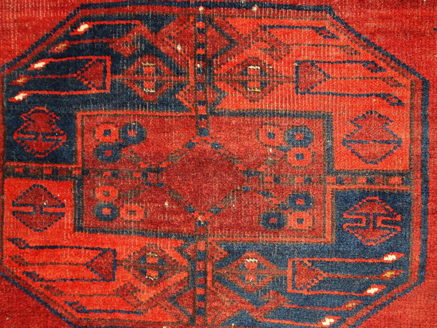 Antique Afghan Ersari rug in original condition, it has some low pile. The rug is from the mid 20th century made in red wool.