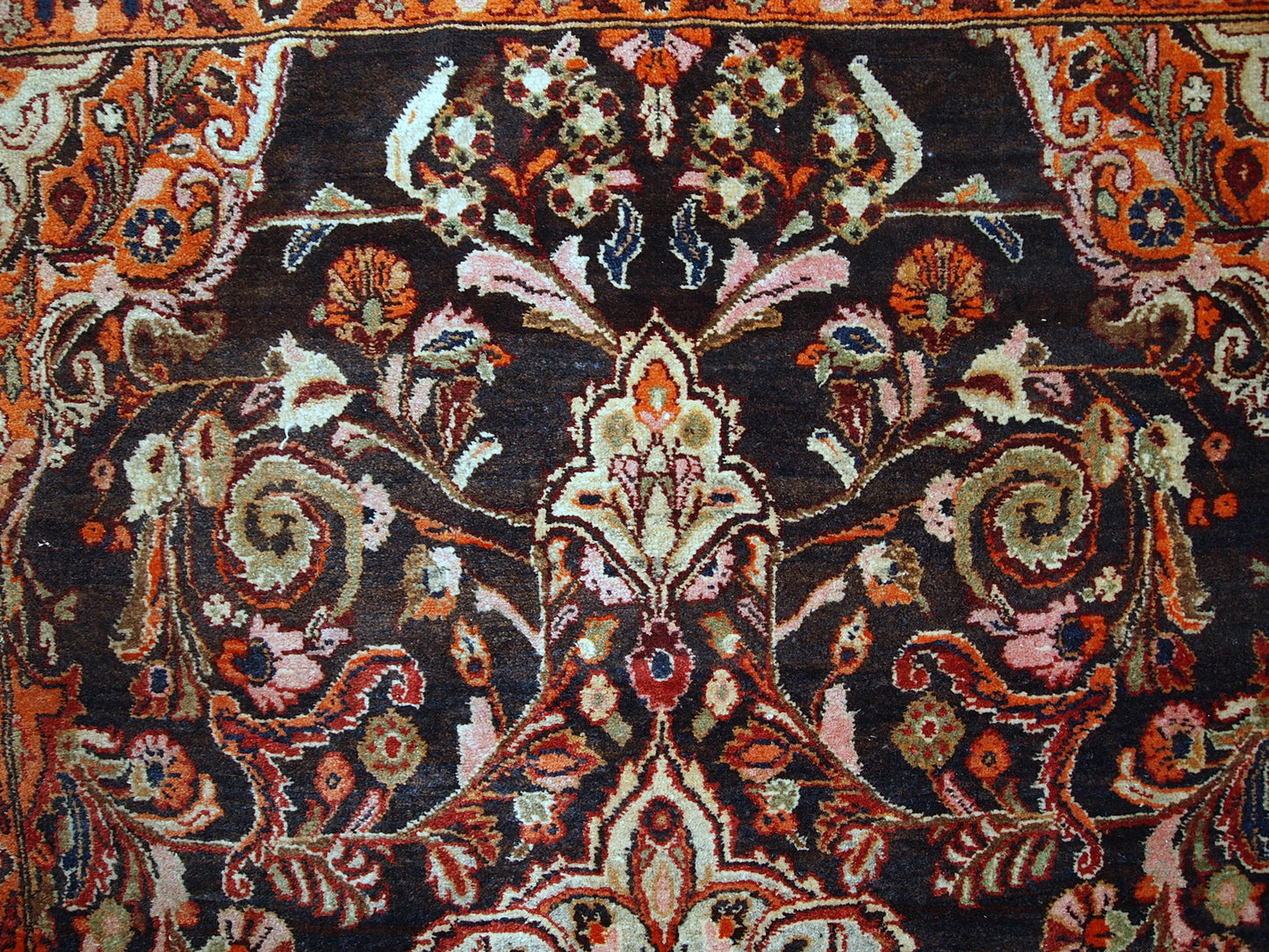Vintage Persian Tabriz rug in original good condition. It is in chocolate brown and orange wool with some olive and pink shades.