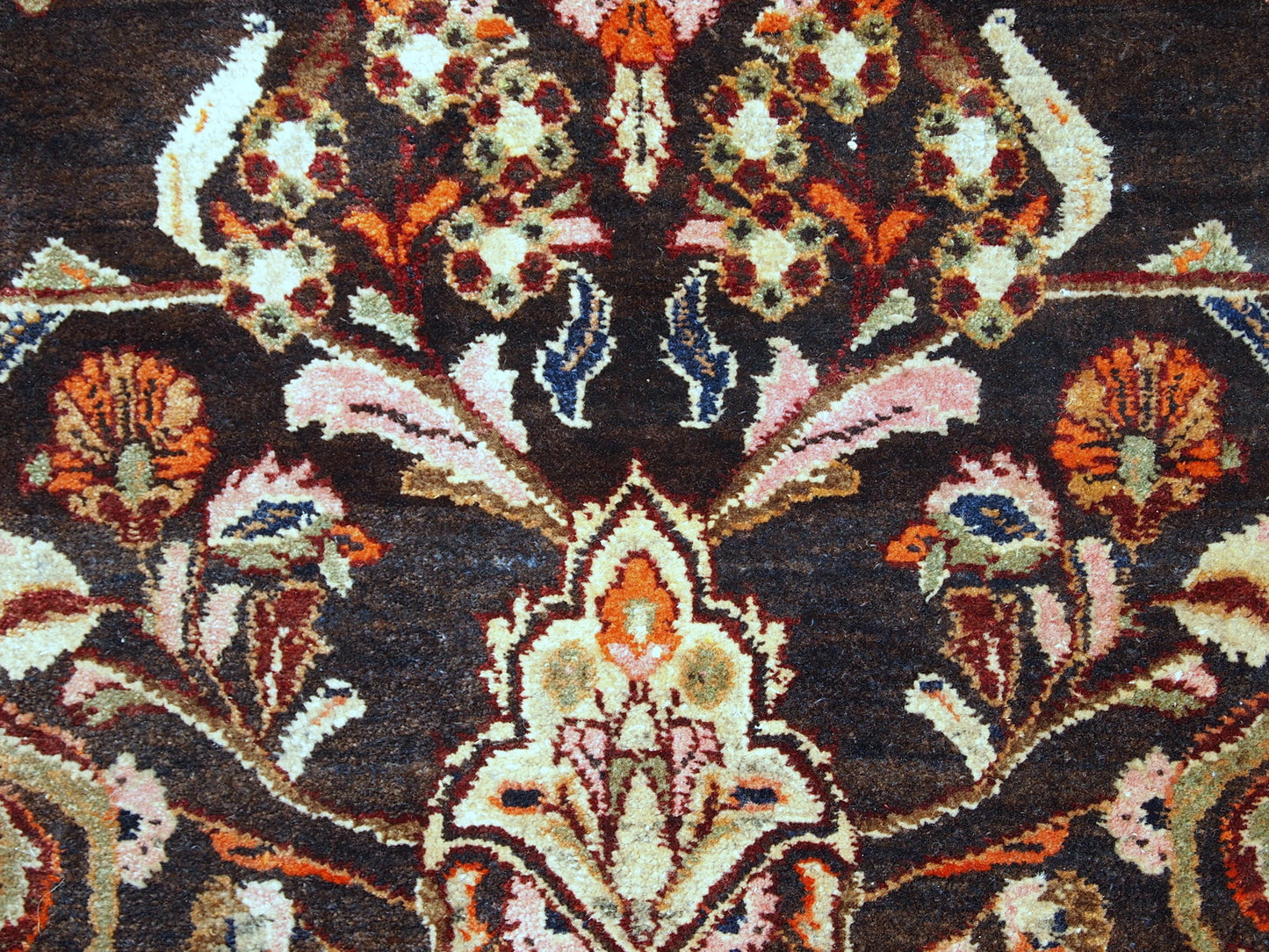 Vintage Persian Tabriz rug in original good condition. It is in chocolate brown and orange wool with some olive and pink shades.