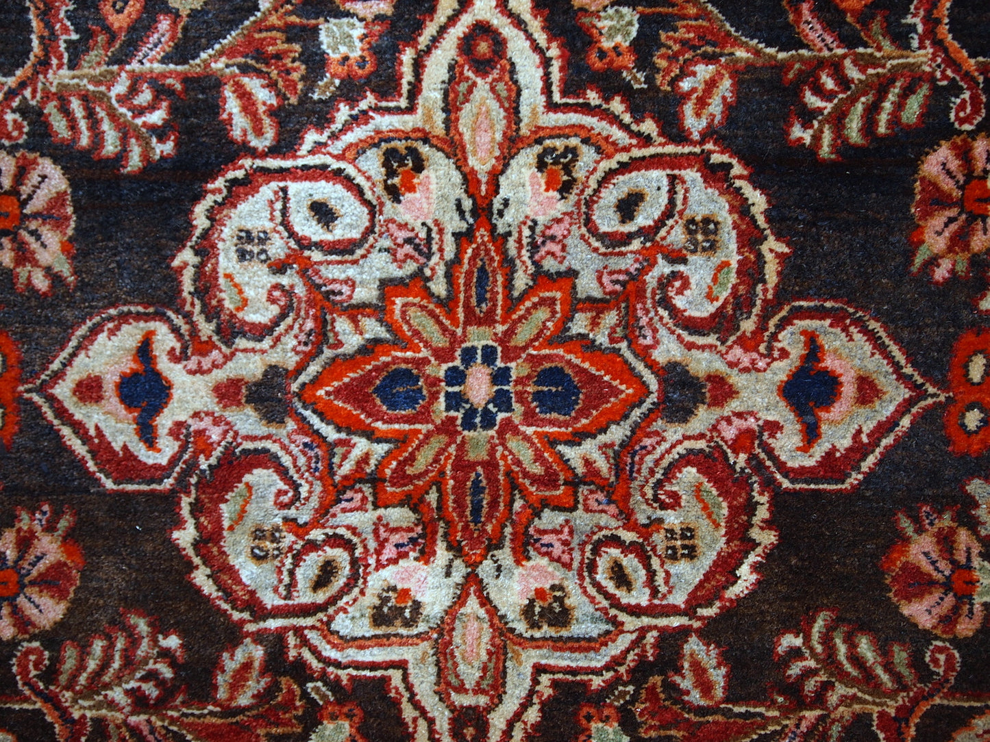 Vintage Persian Tabriz rug in original good condition. It is in chocolate brown and orange wool with some olive and pink shades.