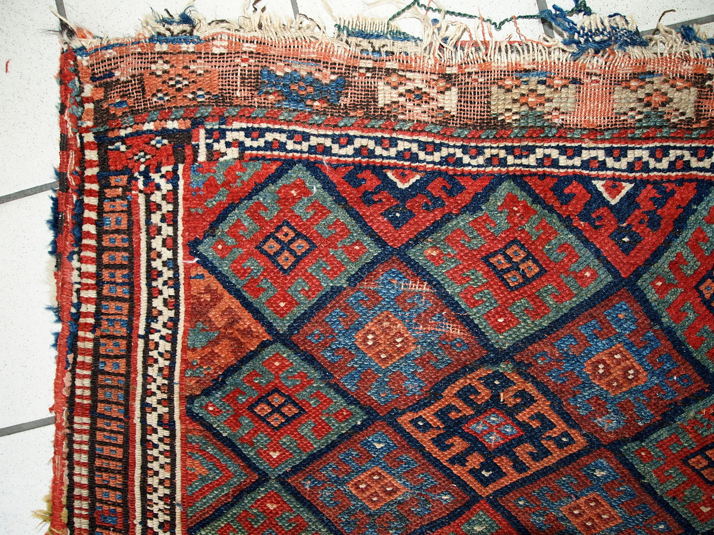 Hand made antique collectible Persian Kurdish bag in original condition, it has some age wear. This bag has typical Jaff design with repeating diamond in different shades. The back side kilim is striped in red and chocolate brown shades.