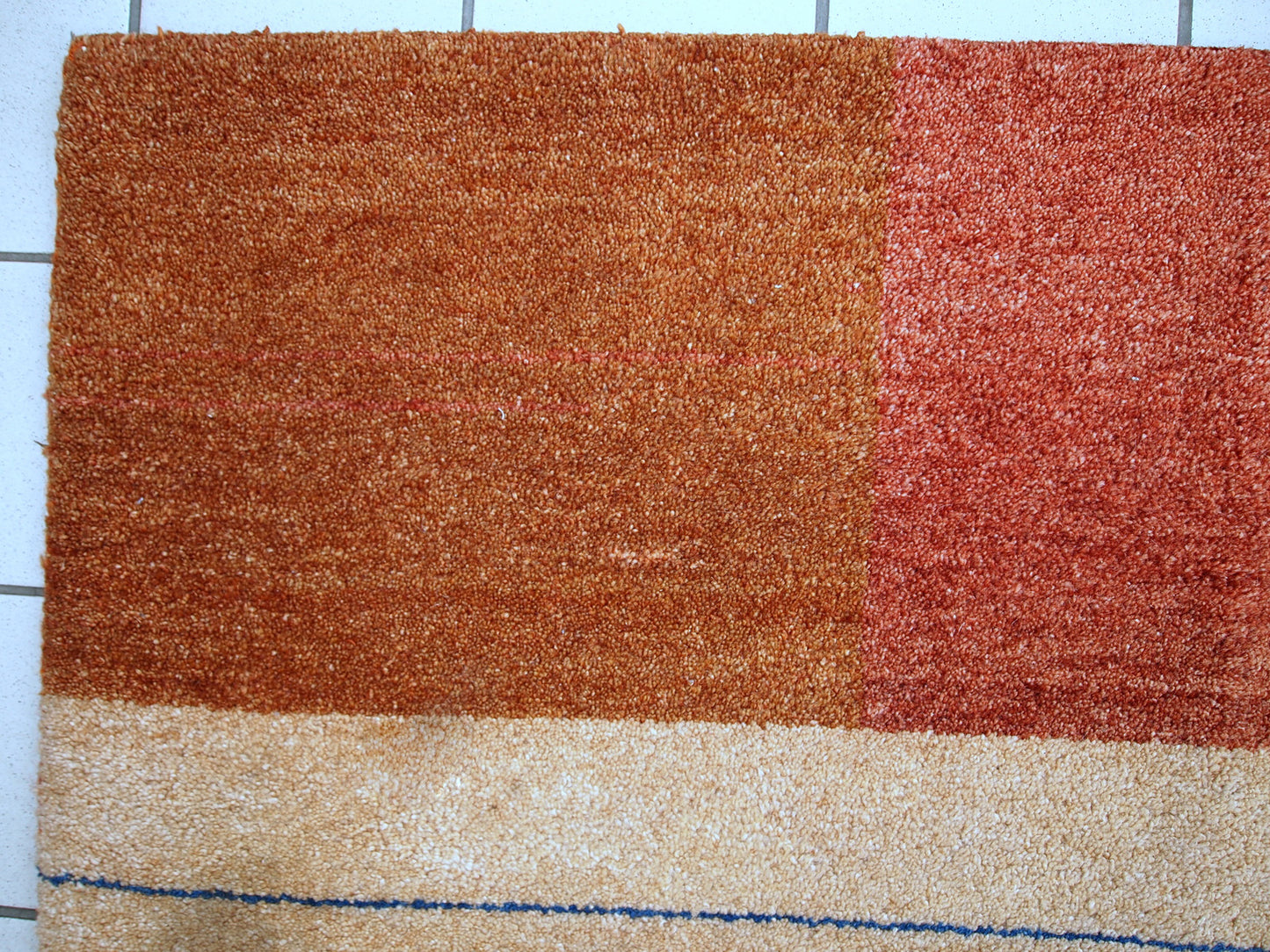 Vintage Persian Gabbeh rug in original good condition. It is in brownish, beige and red wool with geometric design, made in the end of 20th century.