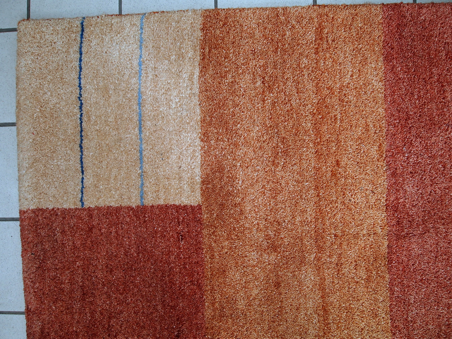 Vintage Persian Gabbeh rug in original good condition. It is in brownish, beige and red wool with geometric design, made in the end of 20th century.