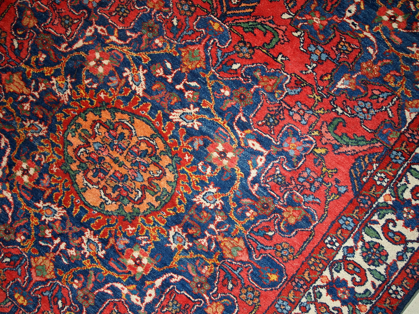 Vintage Persian Mashad rug in original good condition. It has been hand-weaved in the end of 20th century in wool.