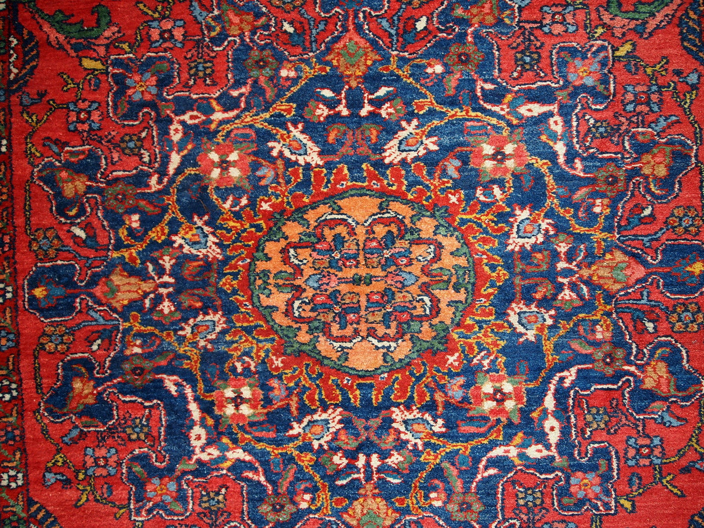 Vintage Persian Mashad rug in original good condition. It has been hand-weaved in the end of 20th century in wool.