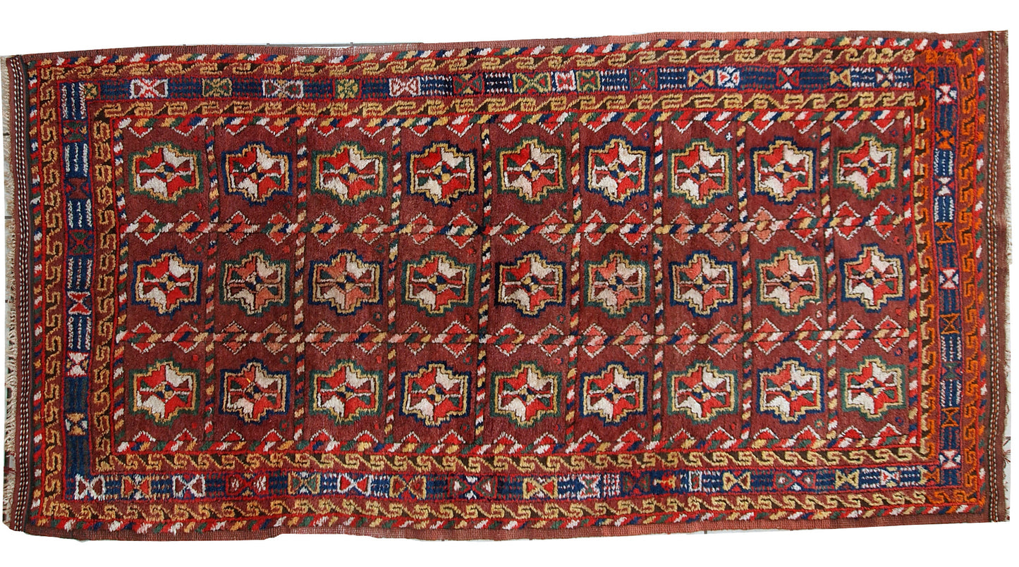 This antique Kurdish rug made in deep shade of burgundy. All-over design with geometric and tribal accents. The wool on the rug is soft, it is in original good condition.