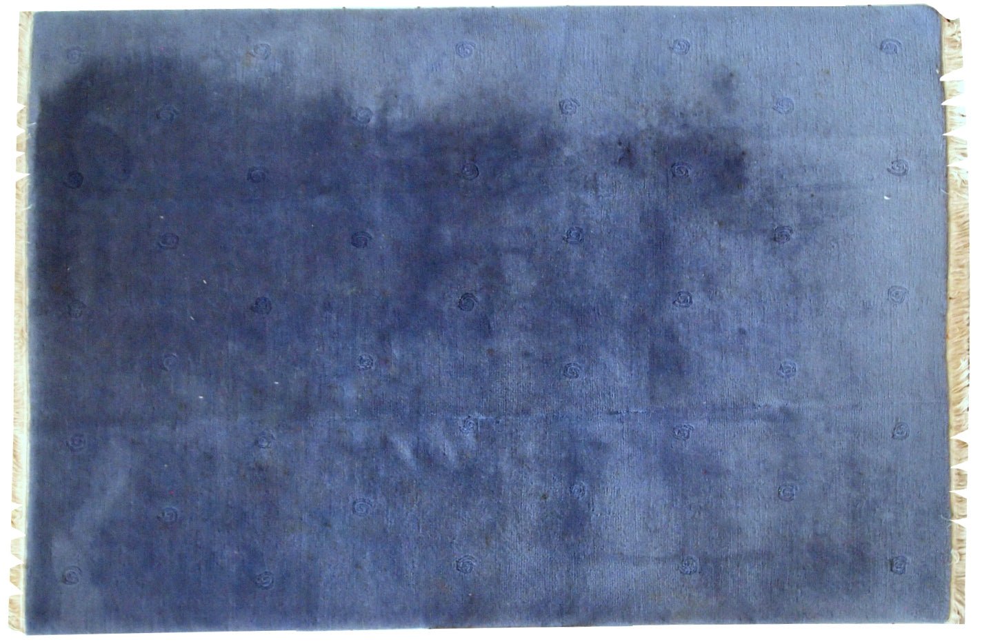 Vintage Tibetan Khaden rug in a variety of shades from dirty blue to a bright blue (depends on the light). The rug has a thick soft wool, it is quite heavy. Full pile, has some age discolorations. Plain design with minimal decor on it.