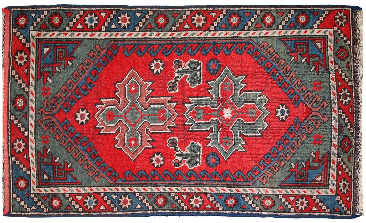 Turkish Anatolian antique handmade rug in bright red and green shades. The rug is in original good condition, it has some low pile.