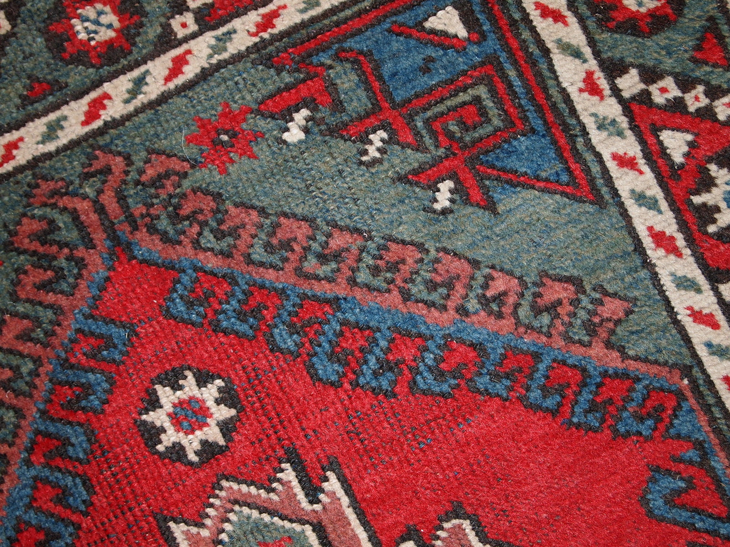 Turkish Anatolian antique handmade rug in bright red and green shades. The rug is in original good condition, it has some low pile.