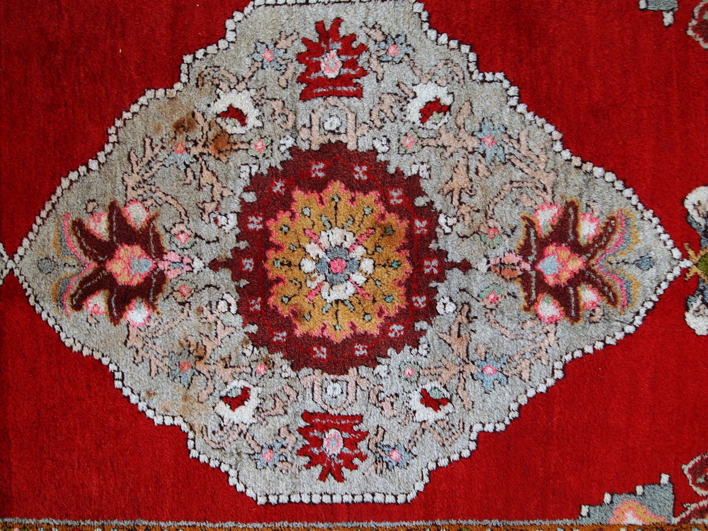 Vintage woolen Turkish Oushak runner in original good condition. It is in bright red shades with sky blue medallions. The wool is very soft.
