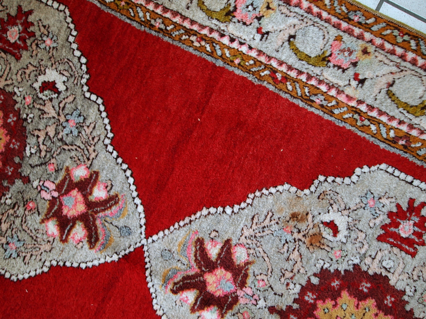 Vintage woolen Turkish Oushak runner in original good condition. It is in bright red shades with sky blue medallions. The wool is very soft.