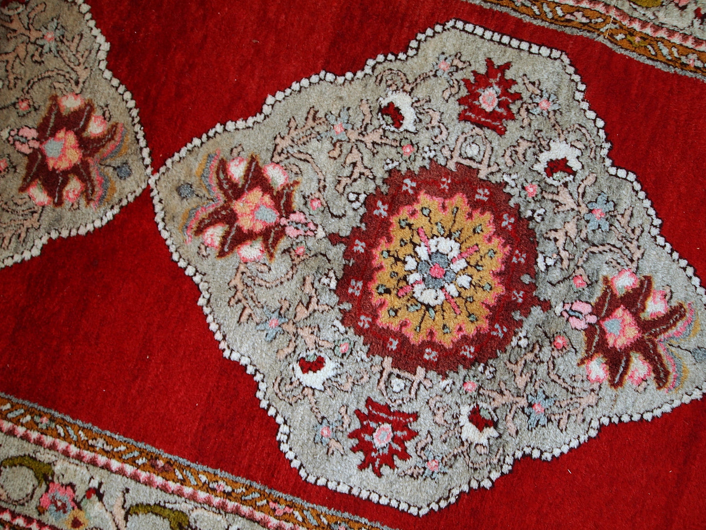 Vintage woolen Turkish Oushak runner in original good condition. It is in bright red shades with sky blue medallions. The wool is very soft.