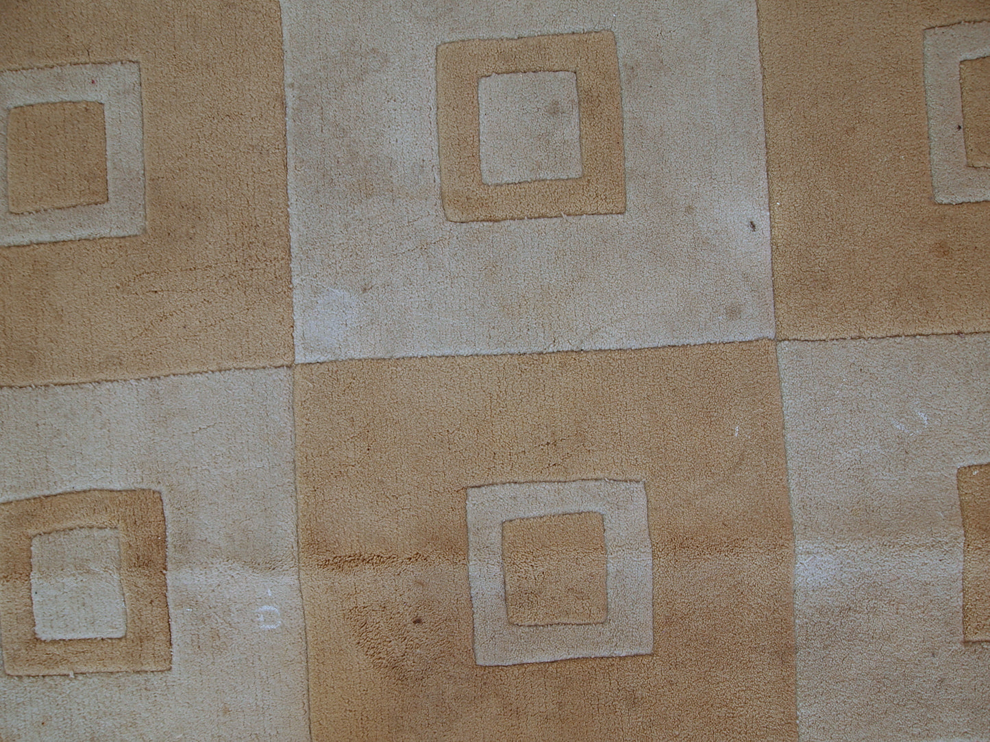 Handmade Chinese rug in light shades of white and brown. It has modern geometric design. The rug made out of acrylic in China. It is in original condition, has some age discolorations.