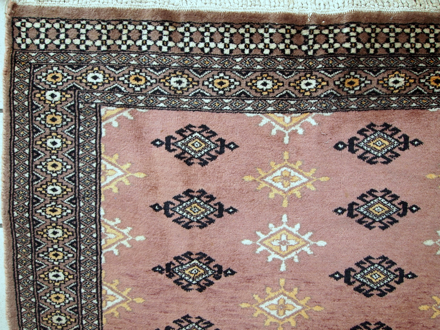 Handmade vintage Uzbek Bukhara rug in original good condition. The rug made in soft wool of peach shade.