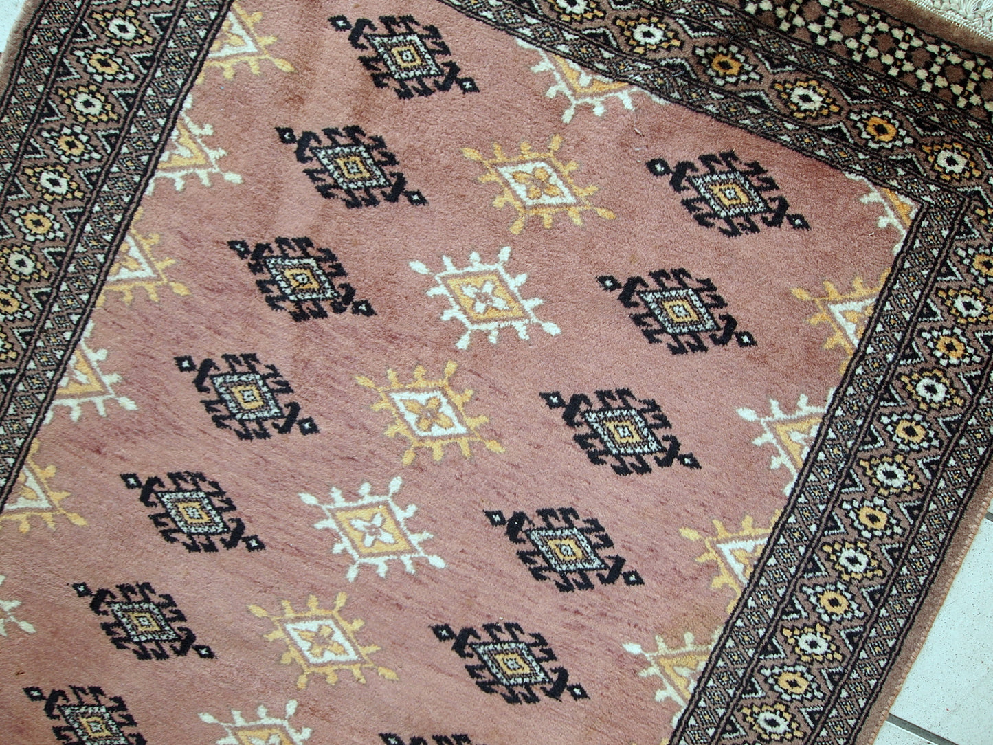 Handmade vintage Uzbek Bukhara rug in original good condition. The rug made in soft wool of peach shade.