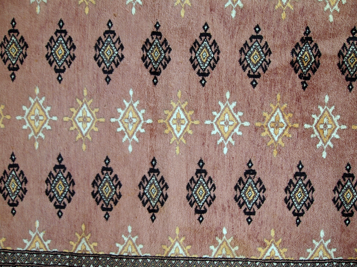 Handmade vintage Uzbek Bukhara rug in original good condition. The rug made in soft wool of peach shade.
