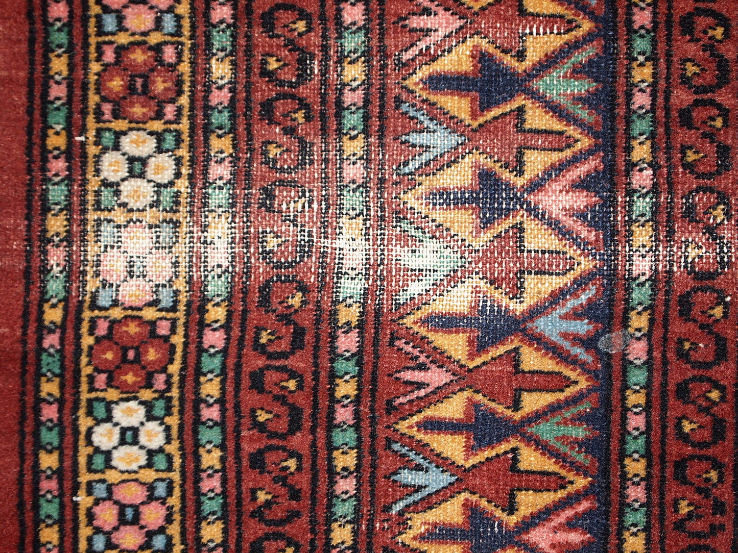 Handmade vintage Uzbek distressed rug in bright red wool. It has been made in the middle of 20th century in Central Asia.