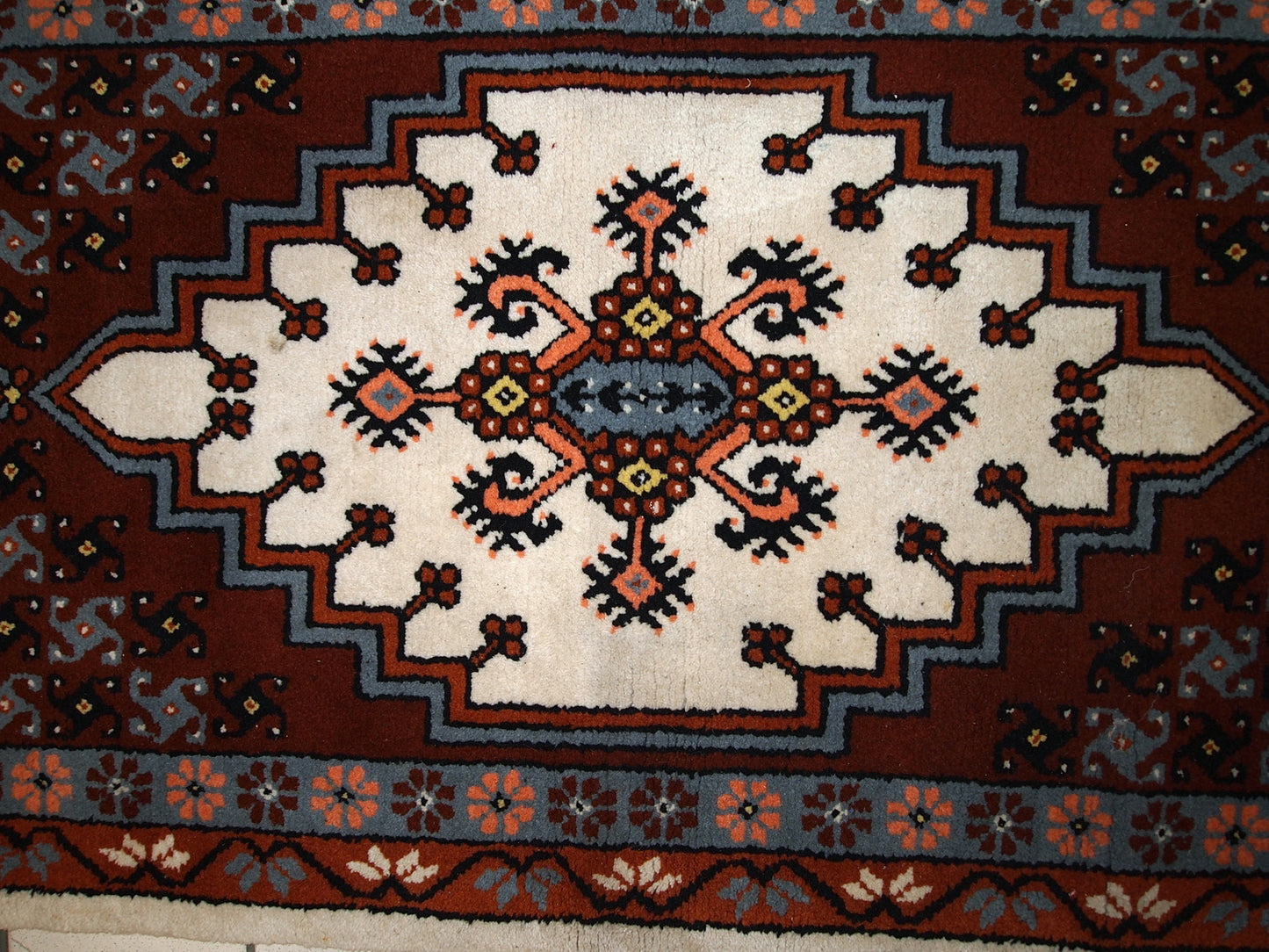 Vintage Berber rug from Morocco in original good condition. The rug made in the end of 20th century in wool.
