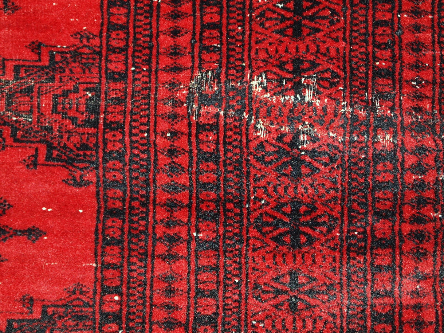 Handmade vintage rug from Afghanistan from the end of 20th century. The rug is in original condition, it has one patch.