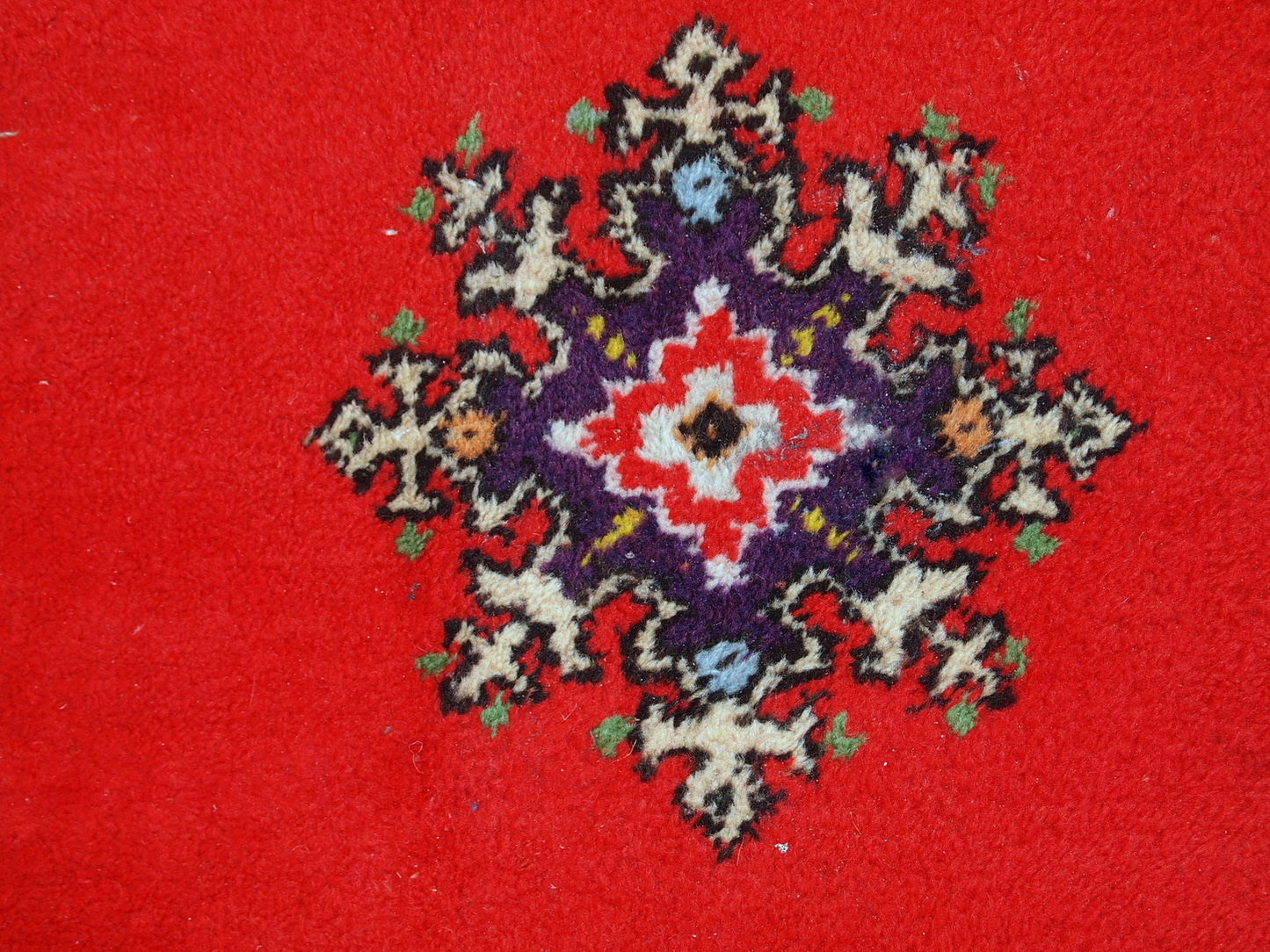 Handmade vintage rug from Berber in Morocco in flashy red wool. The rug is from the end of 20th century in original good condition.