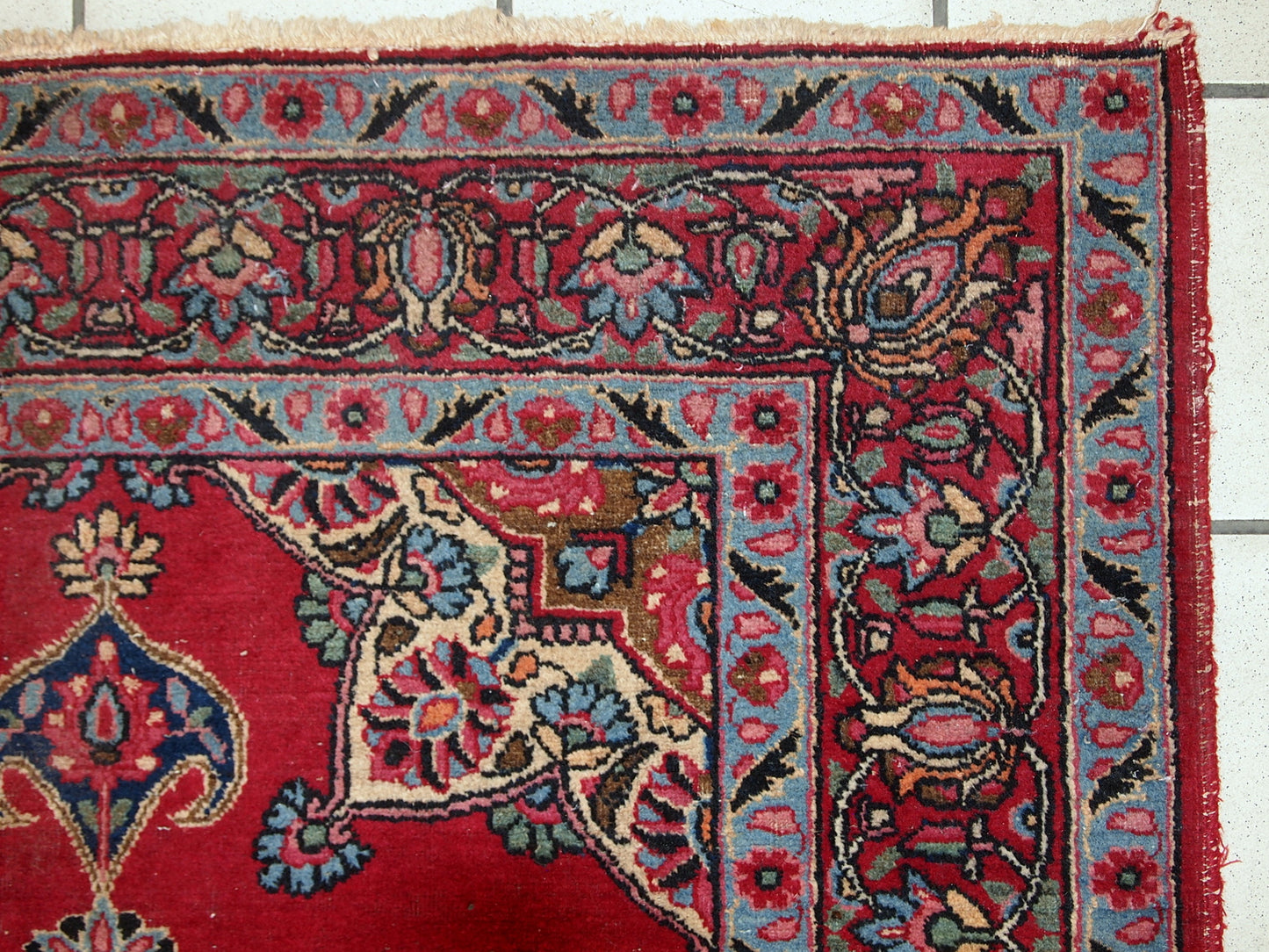 Vintage Persian Kazvin rug in bright red color. The rug is from the end of 20th century. It is in original condition, has some low pile.