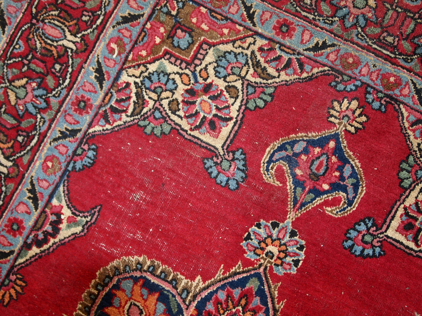 Vintage Persian Kazvin rug in bright red color. The rug is from the end of 20th century. It is in original condition, has some low pile.