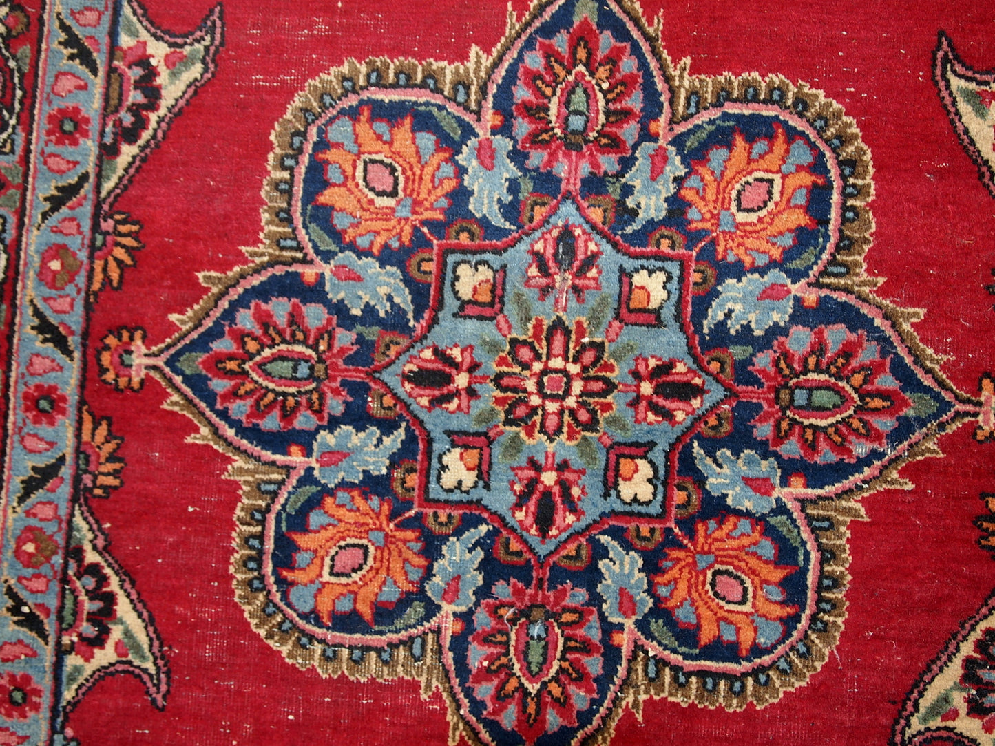 Vintage Persian Kazvin rug in bright red color. The rug is from the end of 20th century. It is in original condition, has some low pile.