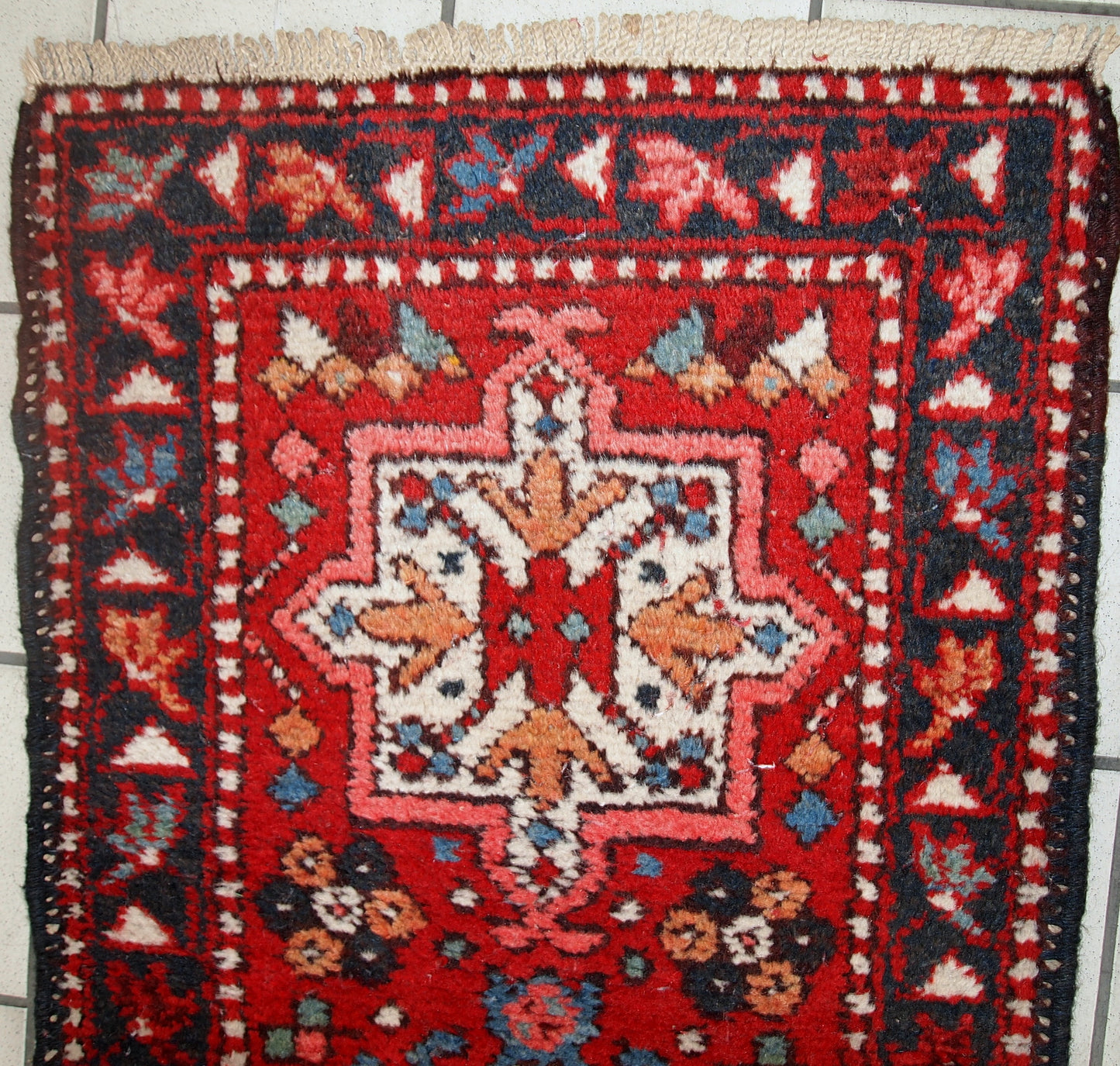 Handmade vintage Karajeh narrow runner in original good condition. The rug is from the middle of 20th century made in wool.
