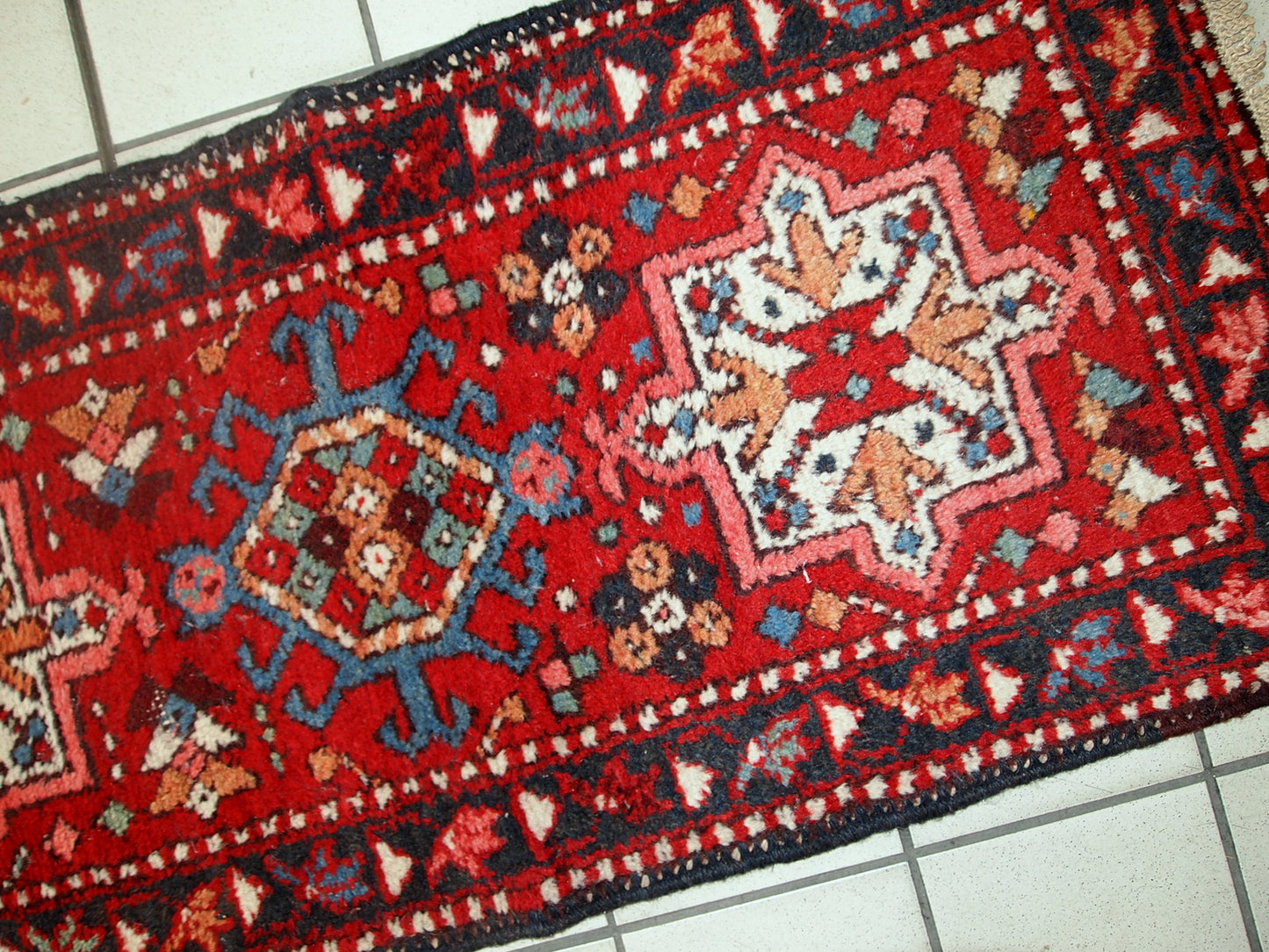 Handmade vintage Karajeh narrow runner in original good condition. The rug is from the middle of 20th century made in wool.