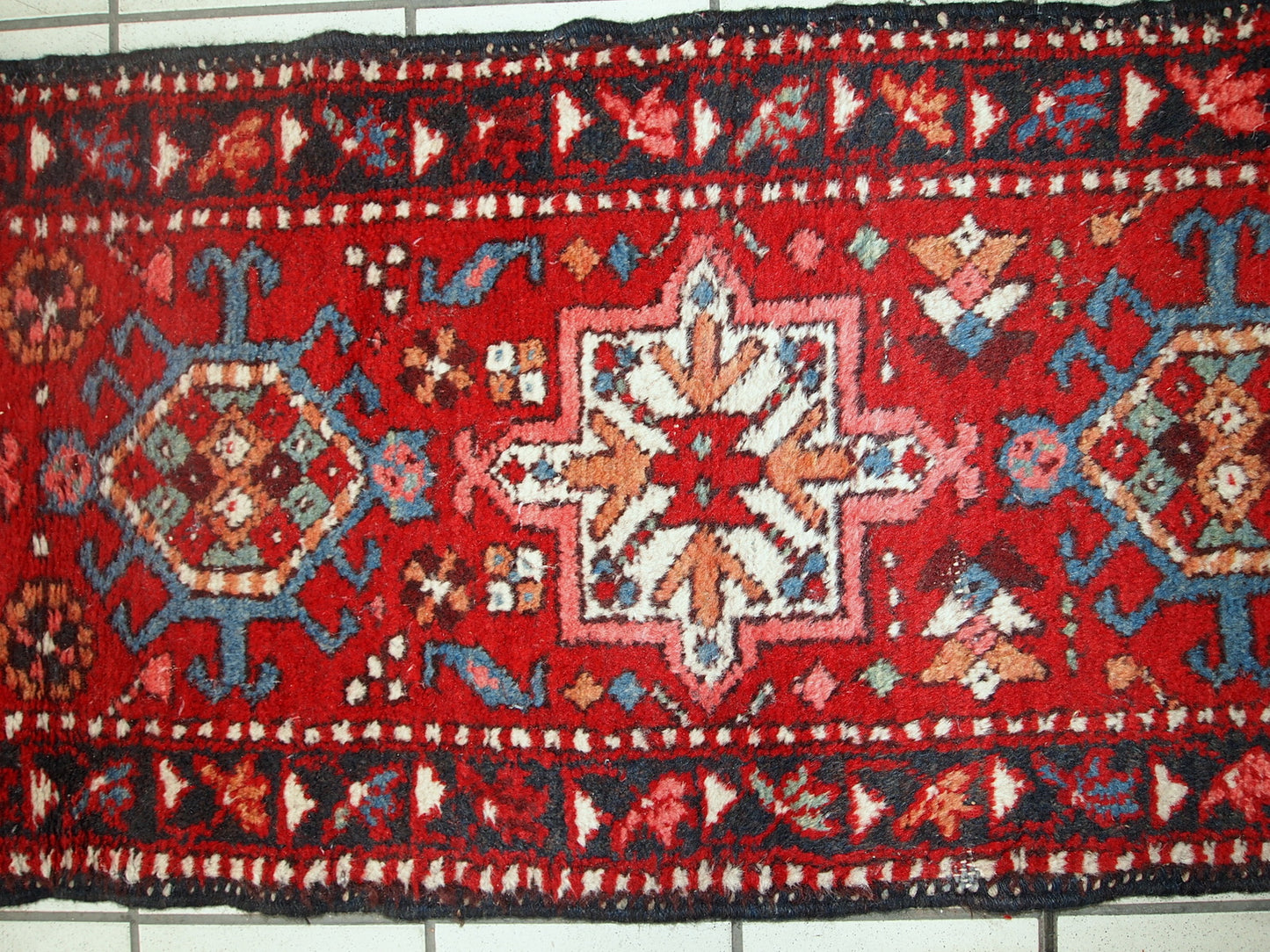 Handmade vintage Karajeh narrow runner in original good condition. The rug is from the middle of 20th century made in wool.