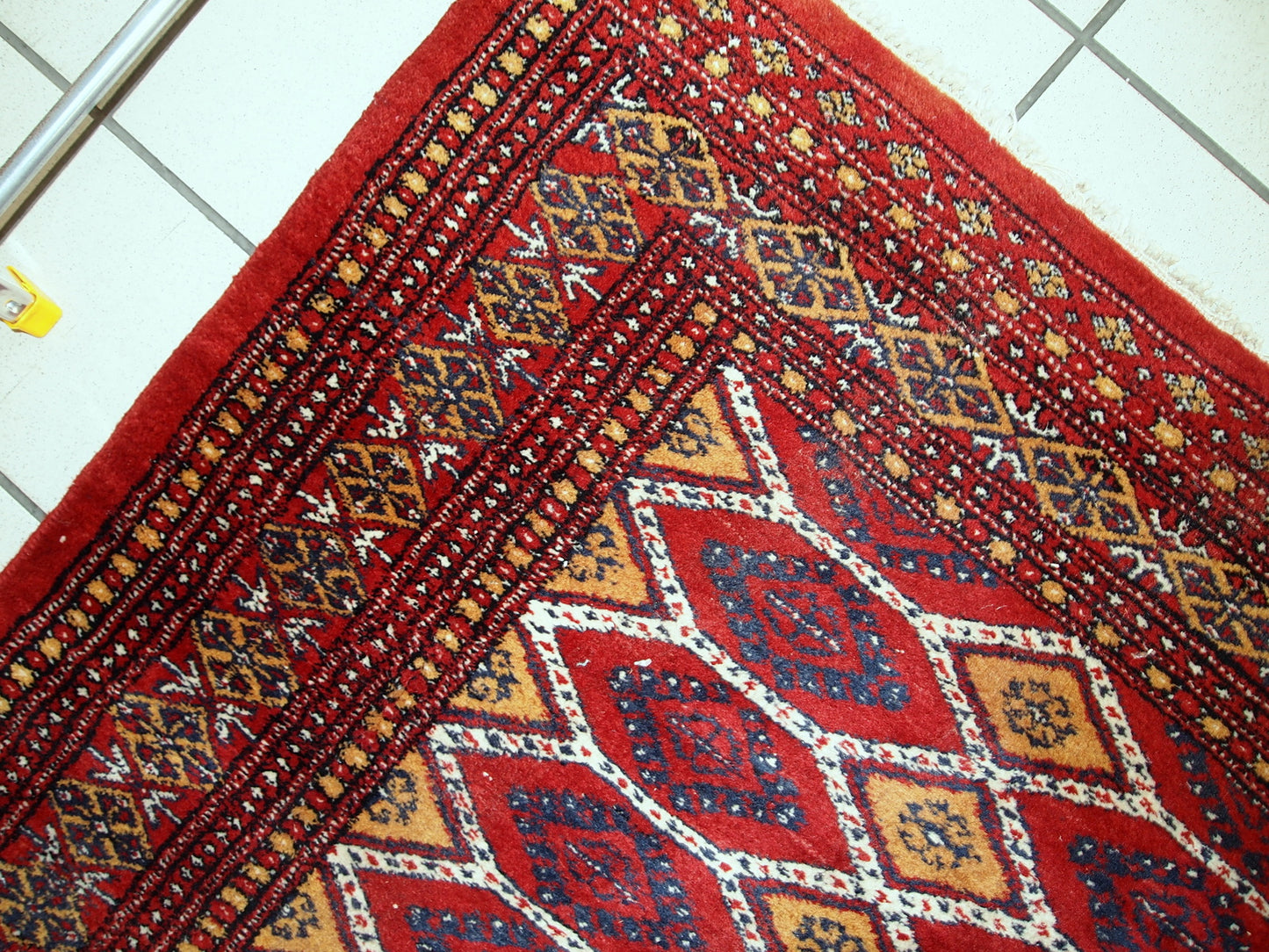 Vintage Uzbek Bukhara rug in red and yellow wool. The rug is from the end of 20th century in original good condition.