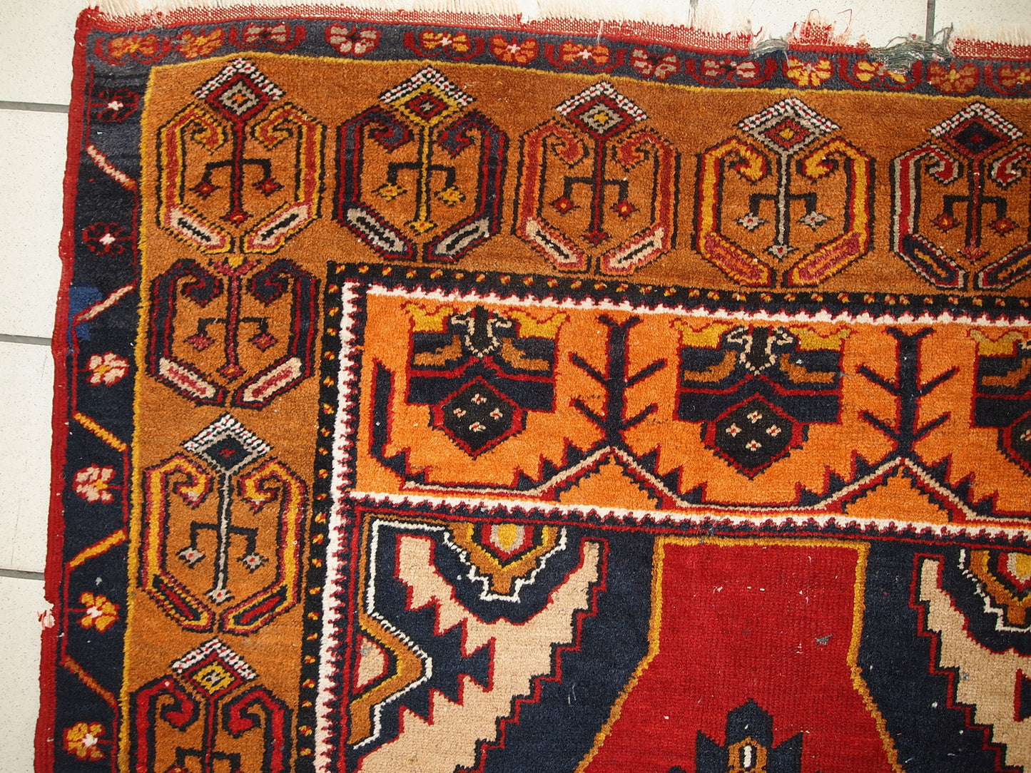 Antique Turkish Anatolian rug in distressed condition. The rug made in traditional Anatolian design in red, yellow, navy blue and grey shades. The rug made in the beginning of 20th century.